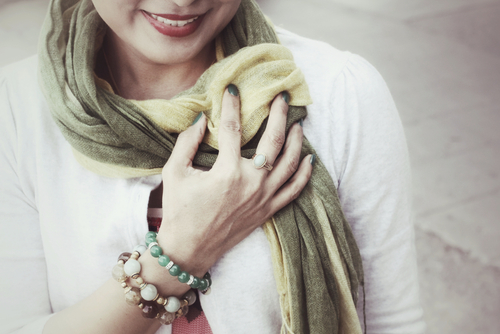 Woman holding green scarf
