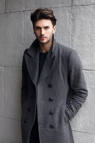 Young man wearing gray trench coat