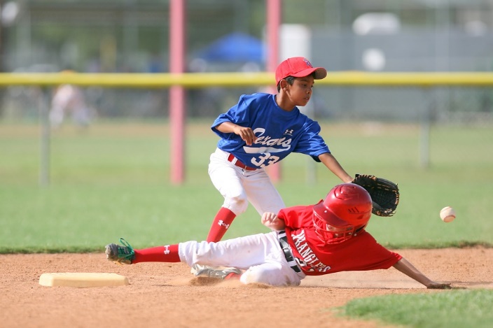 Boy tagging fellow baseball player on base