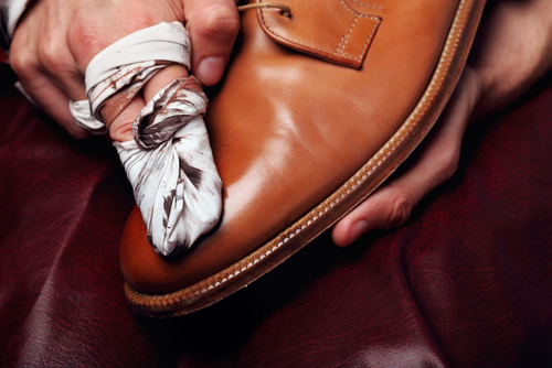 polishing leather shoe with cloth